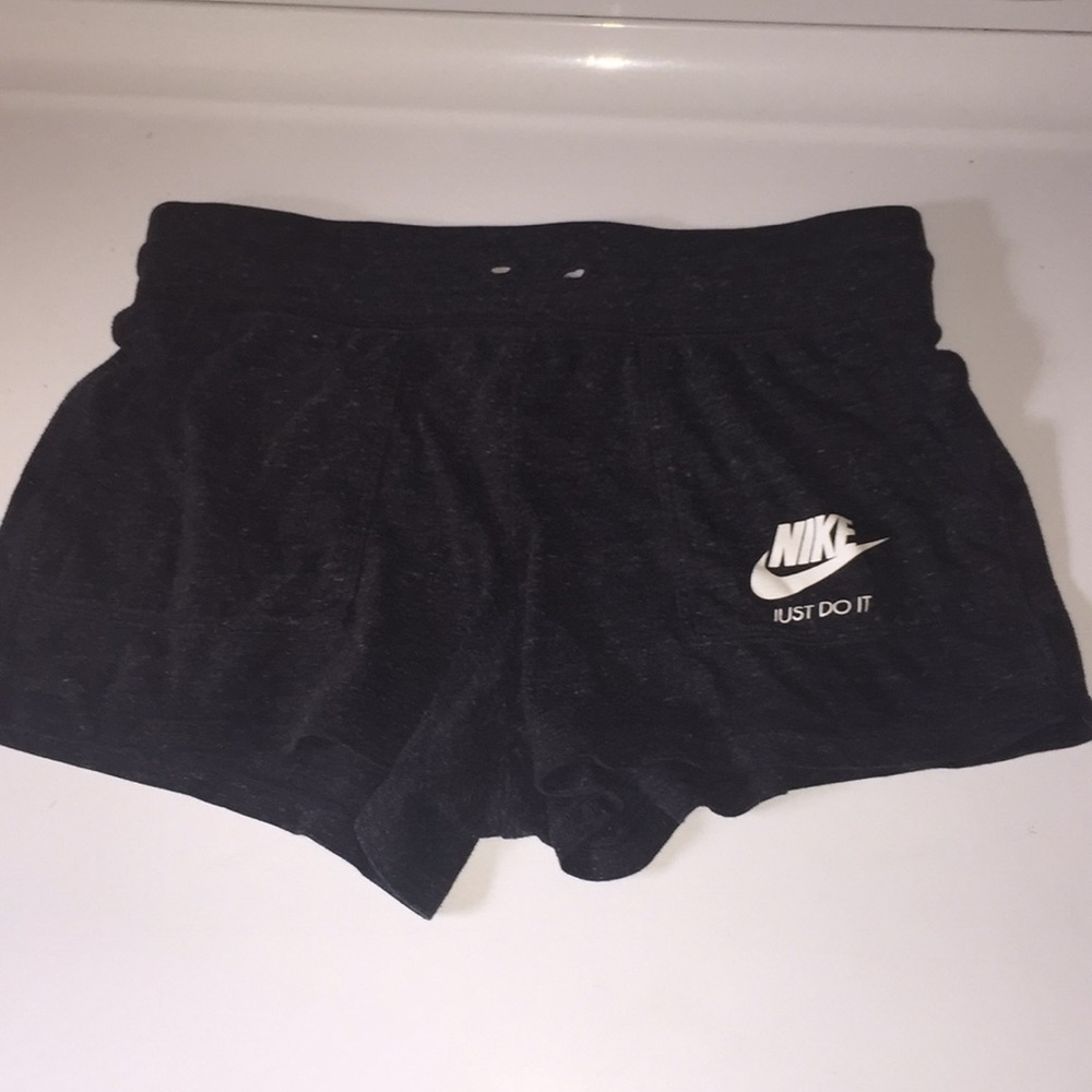 Dark gray loose Nike shorts. (Kids)
